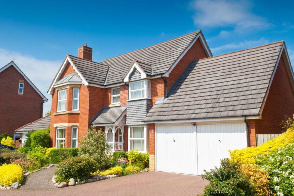 Double white garage doors on detached house - JB Garage Doors