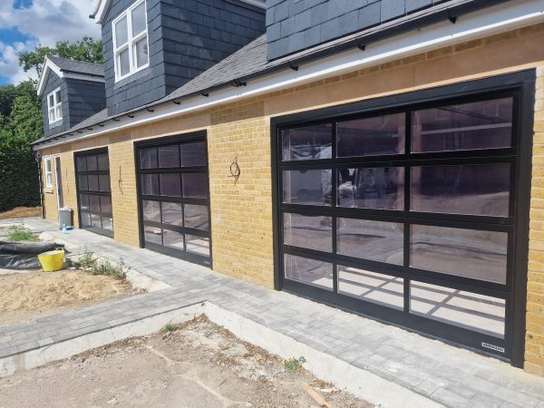 triple sectional garage doors with windows panels
