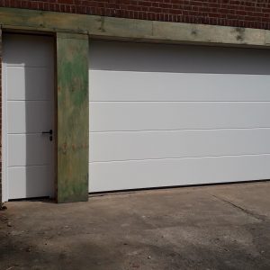 white sectional garage door with front entrance door
