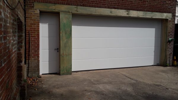 white sectional garage door with front entrance door