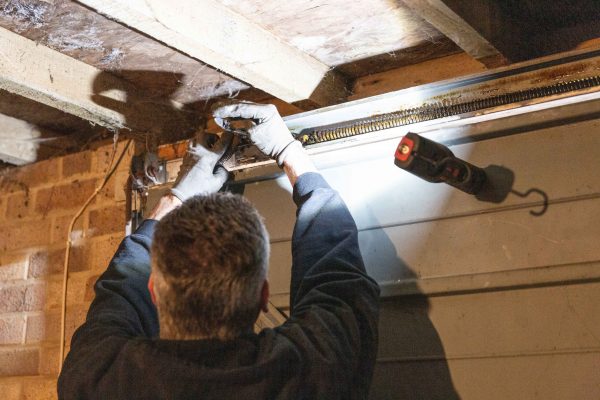 JB Garage Doors employee fixing garage door