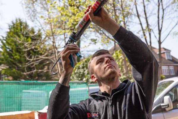 JB Garage Doors employee fixing garage door