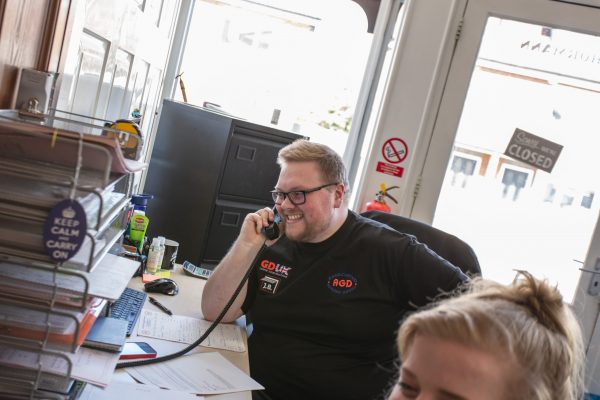 JB Garage Doors team member answering the phone