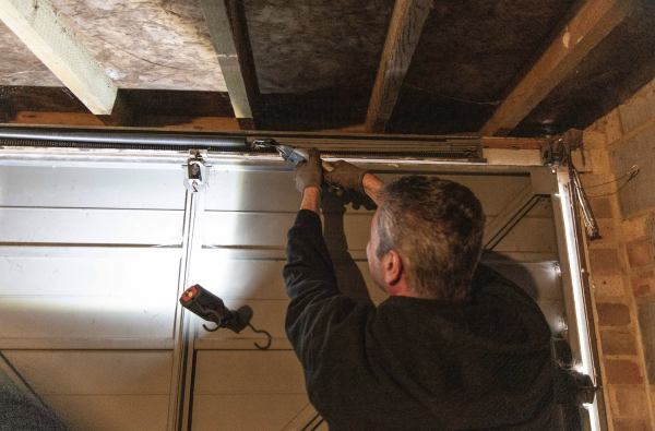 JB Garage Doors employee repairing a new garage door