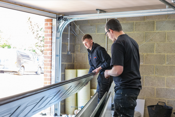 JB Garage Doors team member fitting a new double garage door