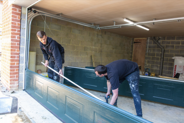 JB Garage Doors team member fitting a new double garage door