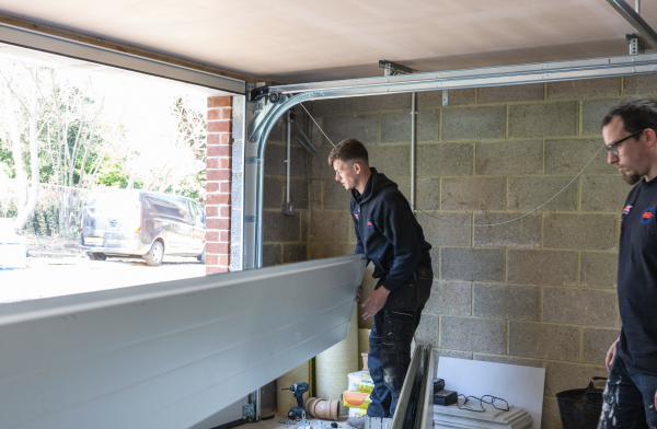 JB Garage Doors team member fitting a new double garage door