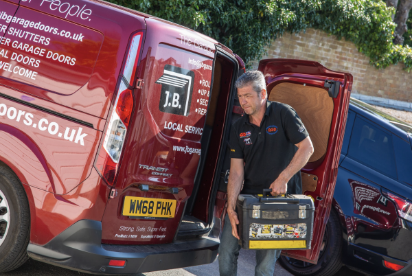 JB Garage Doors employee getting out of van