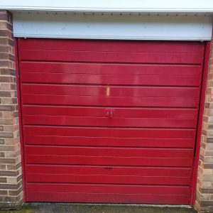 Red fort steel side hinged garage door.