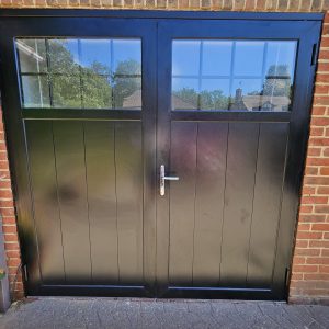 Black traditional windowed garage door by Fort.