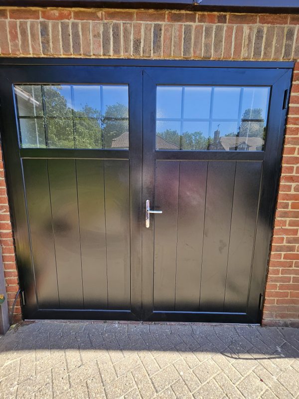 Black traditional windowed garage door by Fort.