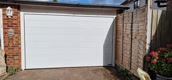 Hormann LPU42 ribbed woodgrain white garage door.