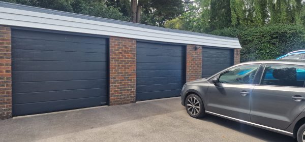Anthracite grey garage door with car.