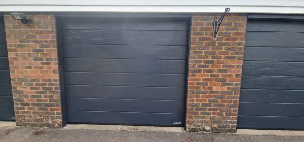 Ribbed woodgrain anthracite grey garage door fitting.