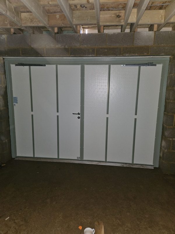 Inside the sage green side hinge door.